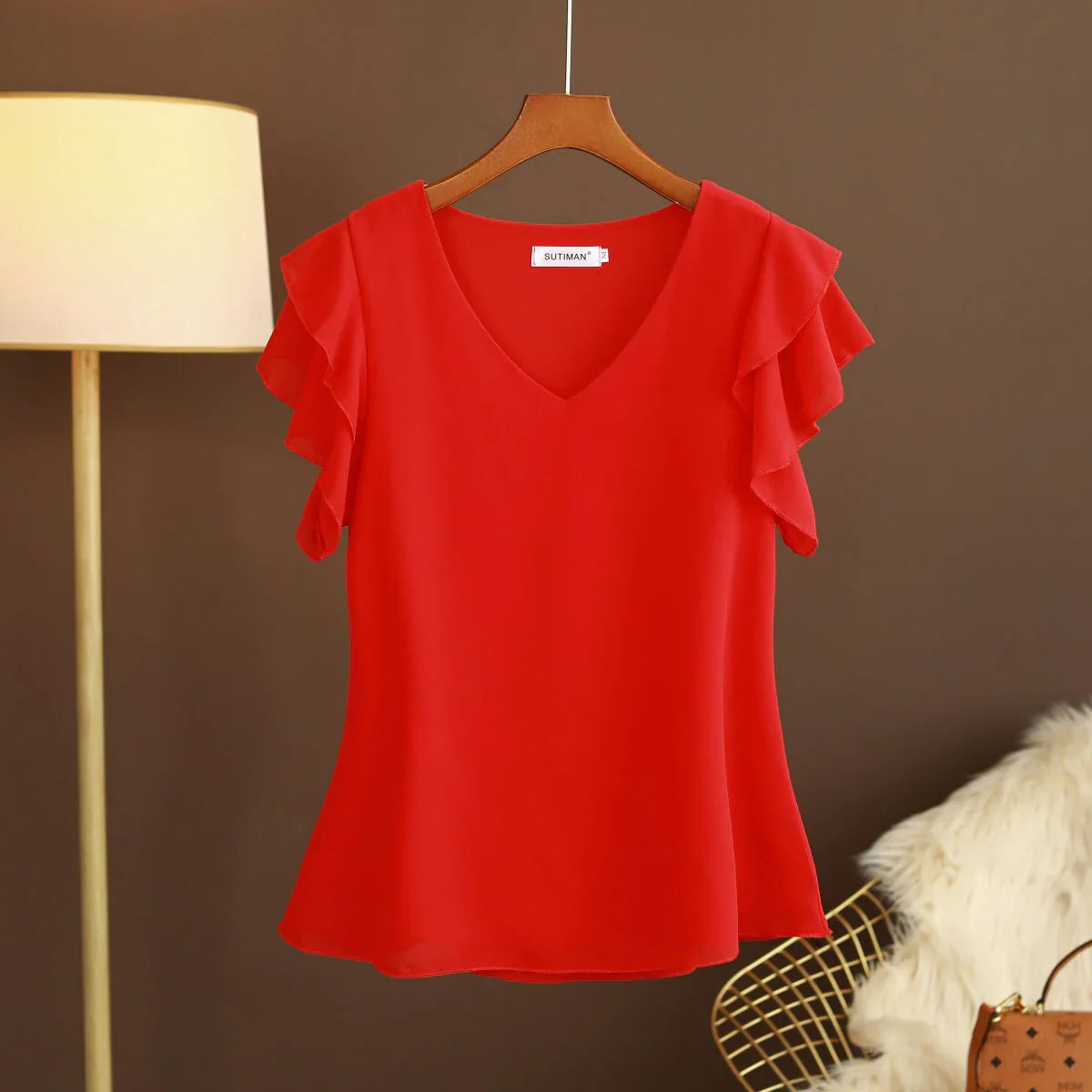 Light women's silk chiffon blouse with ruffled sleeves and V-neck