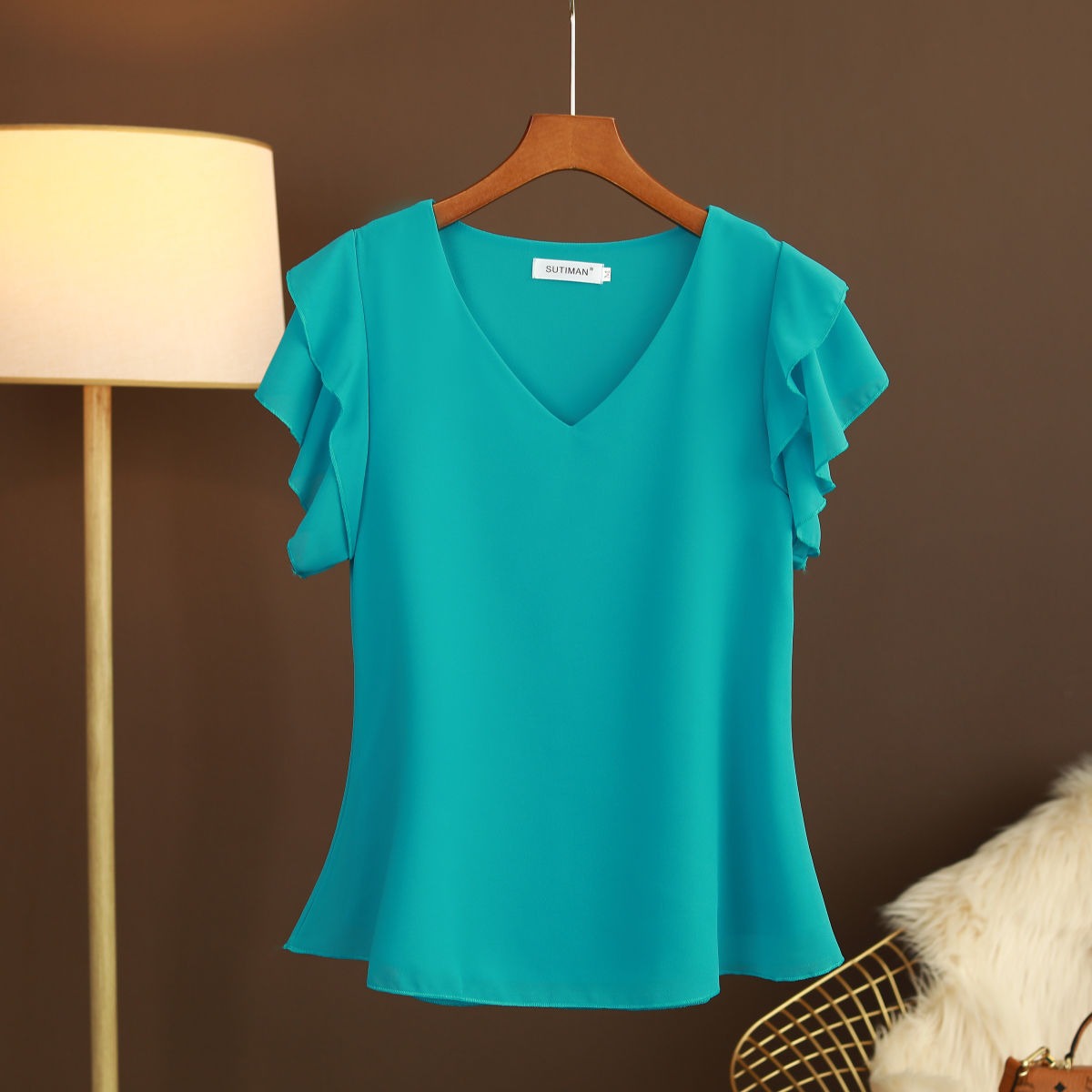 Light women's silk chiffon blouse with ruffled sleeves and V-neck
