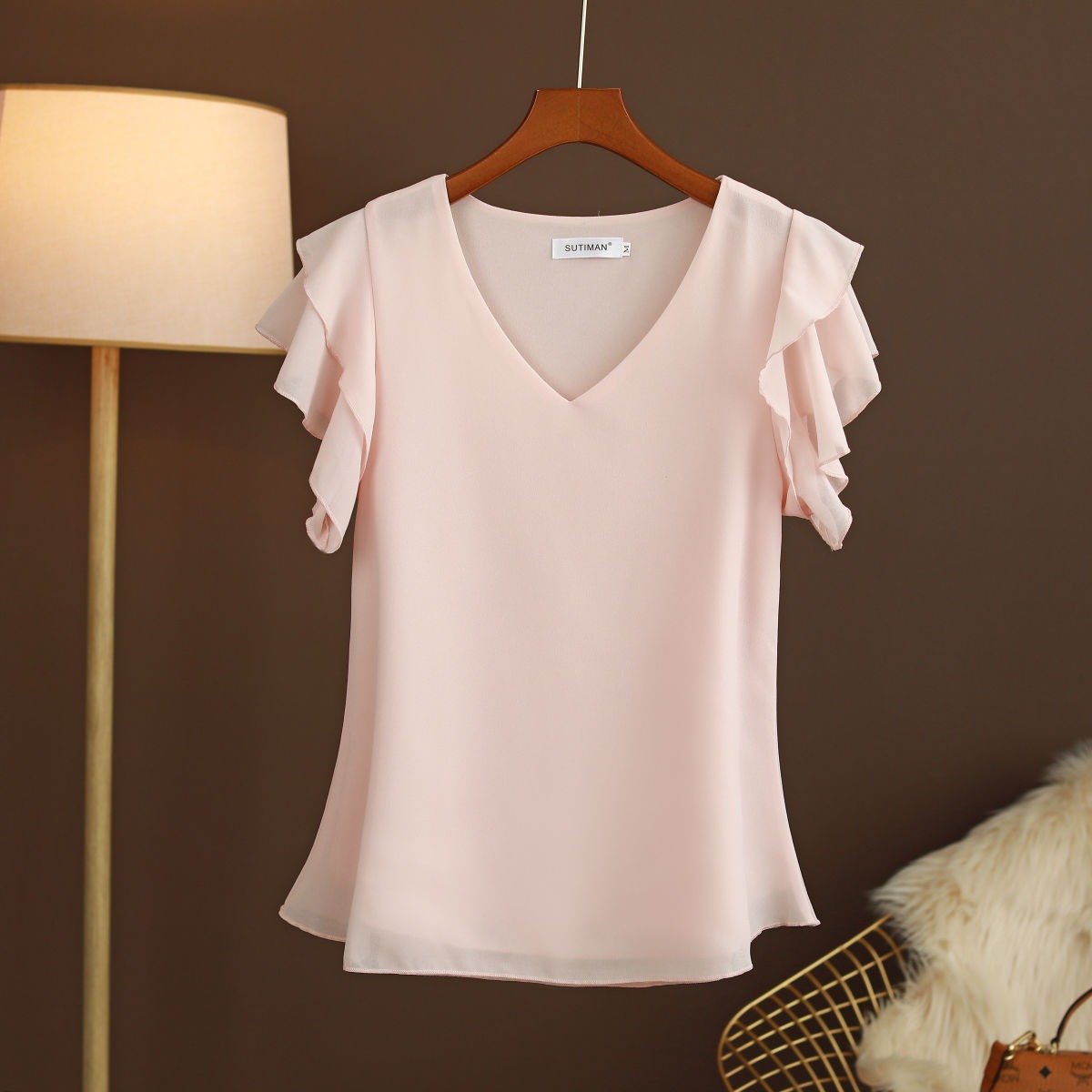 Light women's silk chiffon blouse with ruffled sleeves and V-neck