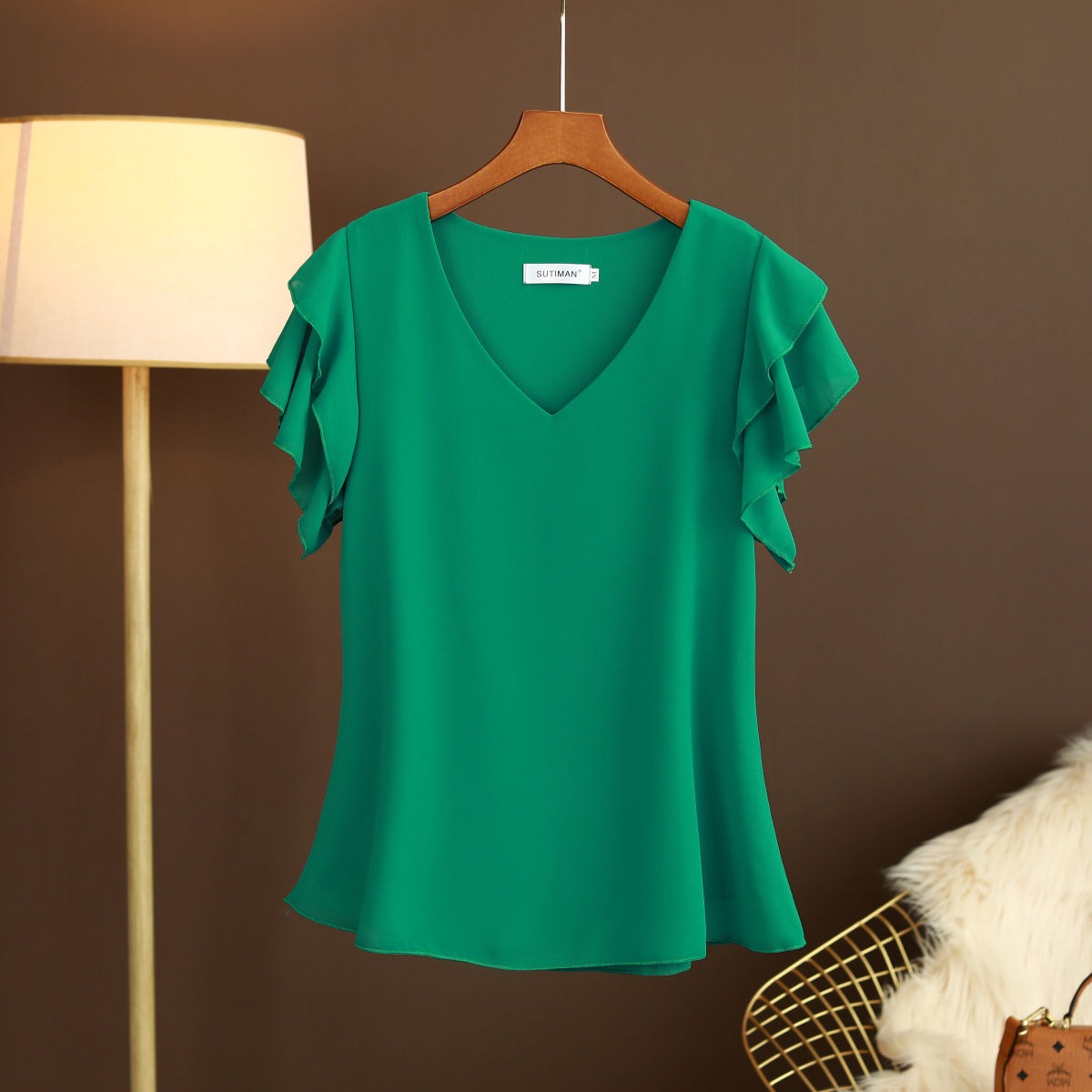 Light women's silk chiffon blouse with ruffled sleeves and V-neck