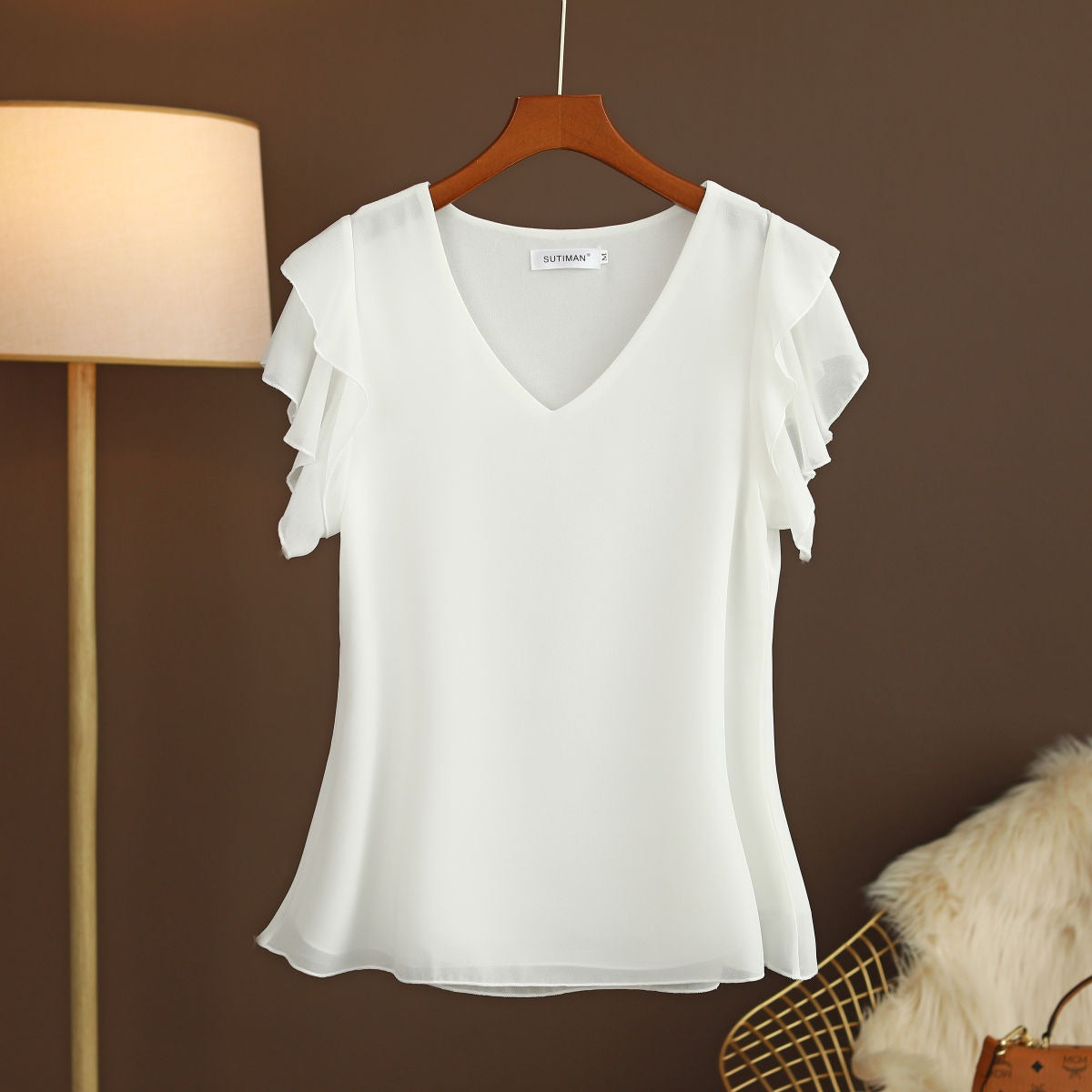 Light women's silk chiffon blouse with ruffled sleeves and V-neck