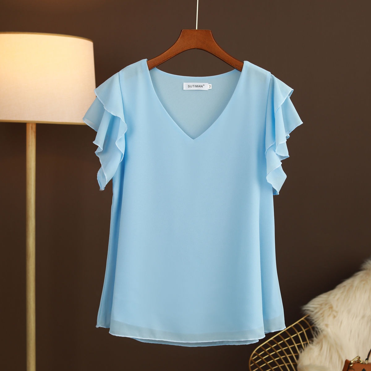 Light women's silk chiffon blouse with ruffled sleeves and V-neck