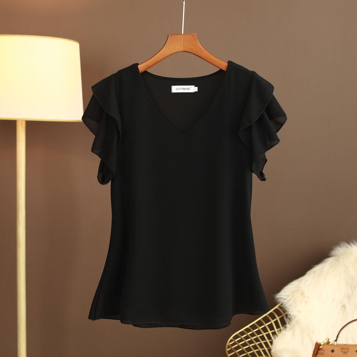Light women's silk chiffon blouse with ruffled sleeves and V-neck