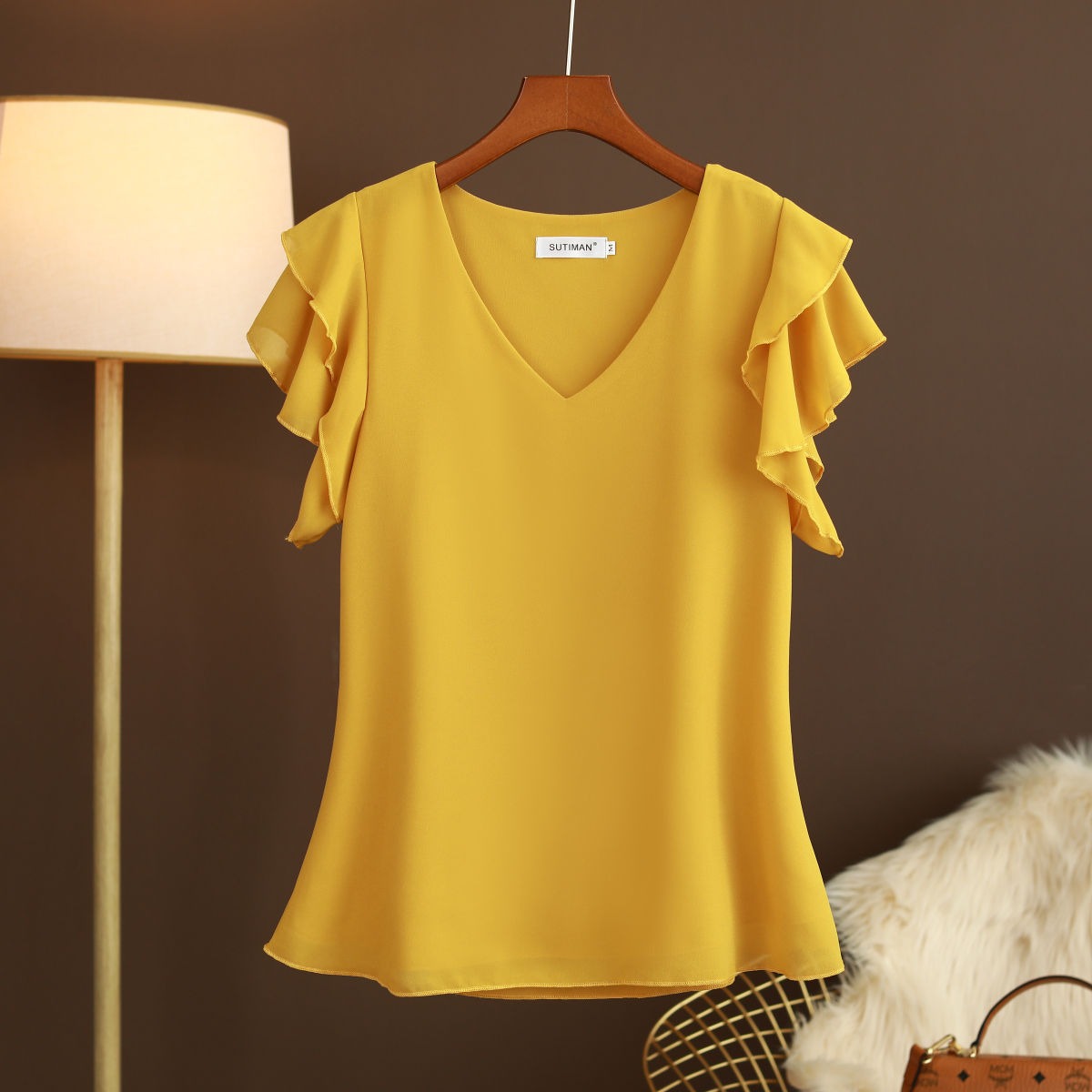 Light women's silk chiffon blouse with ruffled sleeves and V-neck